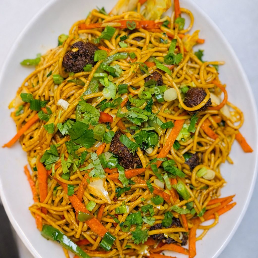 Schezwan Noodles With Veg Manchurian Balls.